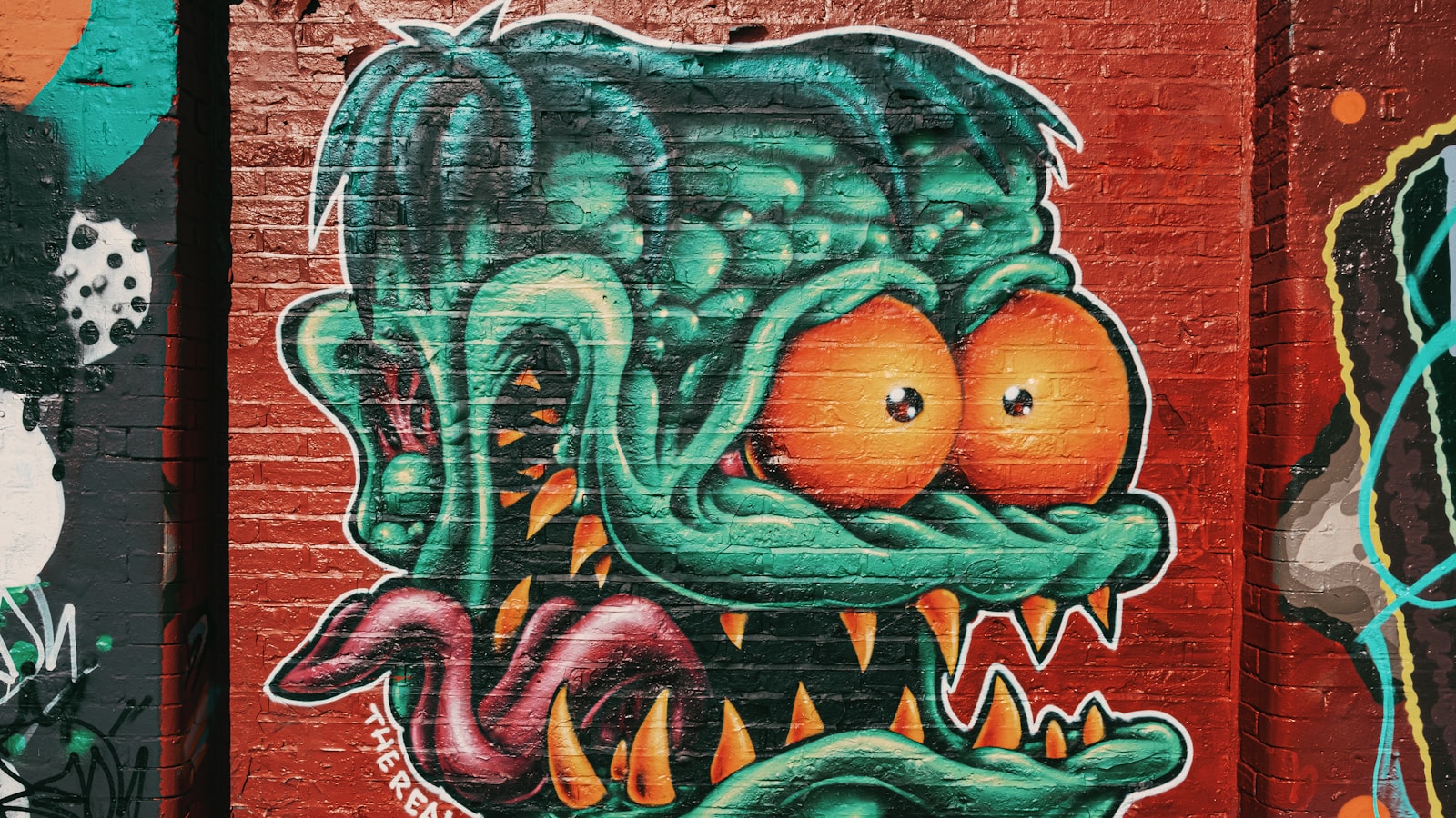 Mural on a red brick wall - British street art
